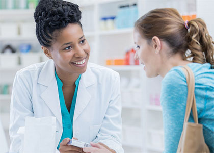 Pharmacist consults with patient about a medication.