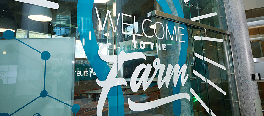 Glass wall entrance to the Pharmapreneurs' Farm that says Welcome to the Farm